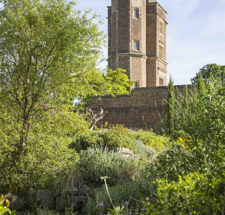 A view of Vita Sackville-West's historic Writng Tower from the completed Delos garden